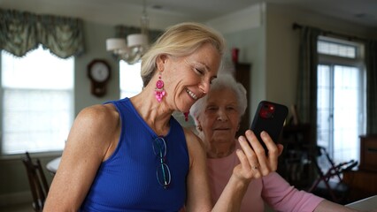 Closeup of mature elderly woman 50s, 60s, holds phone and has video chat talking to family friends...