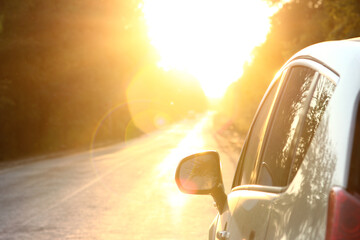 car on the road with sunset