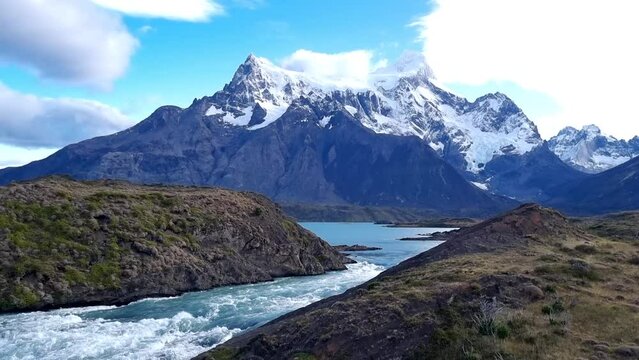 View on scenic waterfall with aquamarine water Salto Grande in National park Torres del Paine between mountains with snow peaks. High quality 4k footage