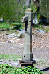 Old rutsy inclined moldy broken hand water pump