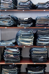 pile of jeans pants in a shop