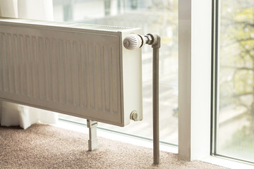 Modern radiator in central heating system in apartment