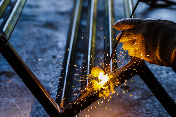 Close up welder man welding metal in construction site, Welder Concept