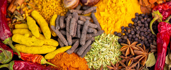 Various spices, peppers and herbs close-up top view. Eastern spice market. A set of peppers and...