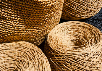 Raffia balls close-up on a wooden board.