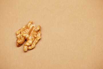 One alone peeled walnut isolated on the bright solid fond plain beige background