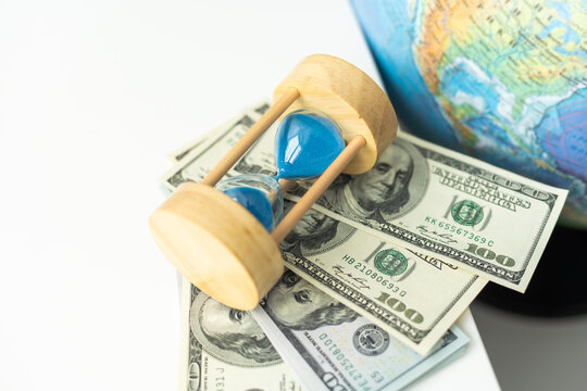 World globe with laptop and hourglass. Online business and globalisation theme