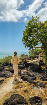 girl walking to get a relaxing african massage in the beach