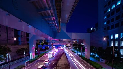 A night timelapse of the traffic jam at the city street in Tokyo wide shot panning