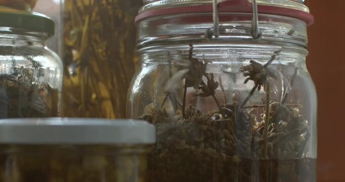 Liquid tincture jars on the moon in natural light. Storage of special plants and substances over time. Herbal remedies glare of the sun. Breakdown of the material.