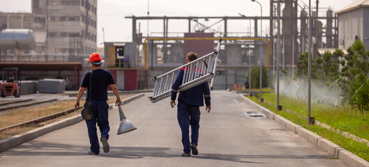 People are working in the industry. Modern technologies work at a cement plant. Technological work on the production of cement. Working atmosphere with copy space. Heaps of sand and soil raw materials