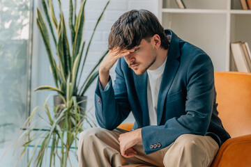 young man sitting with expression of problems or stress