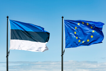 Flag of Estonia and the European Union developing in the wind.