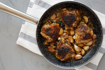 Homemade Chicken With 40 Cloves of Garlic on a Plate, top view. Flat lay, overhead, from above.