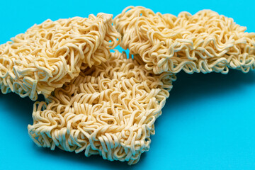 Uncooked Instant Noodles on Blue Background. Raw Pasta. Dry Asian Fast Food. Quick Lunch