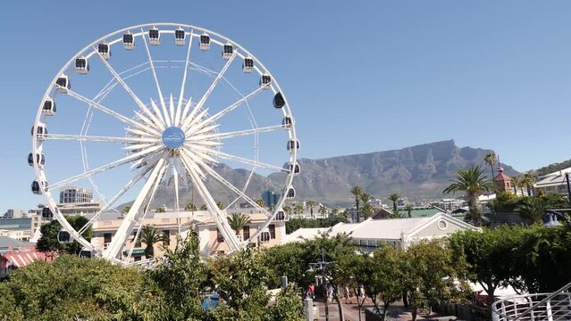 Ferris wheel in Cape Town waterfront. Table Mountain skyline.