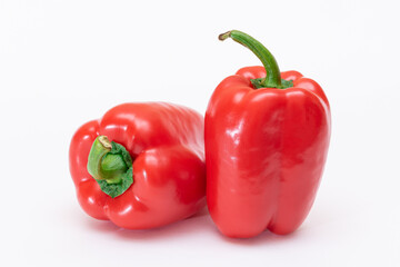 Two Fresh Red Sweet Bell Peppers Isolated on White Background