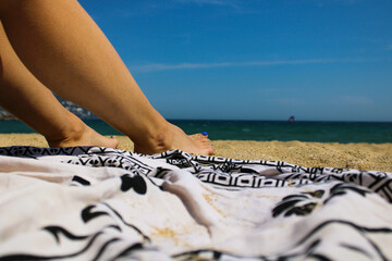 details feet in the sand on the beach on a vacation day