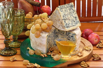 Gorgonzola with grapes and honey on a wooden table