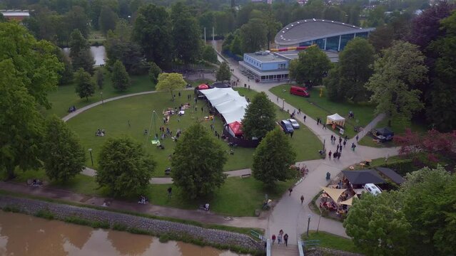Tents on fairground in park on the river. Fabulous aerial top view flight drone