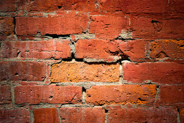 A red brick wall is showing a lot of weathering from the harsh winters we have in Windsor in Upstate NY.  Mortor is starting to crack and expose the edges of these old red bricks.