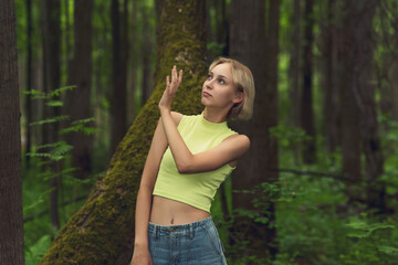young woman in the forest repels a mosquito