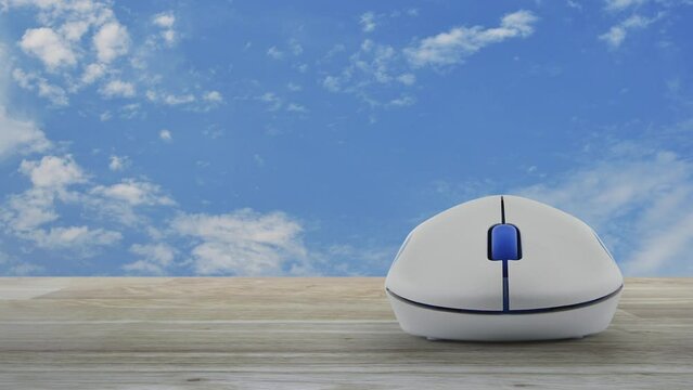 Car with shield flat icon on wireless computer mouse on wooden table over blue sky with white clouds, Business automobile insurance online concept
