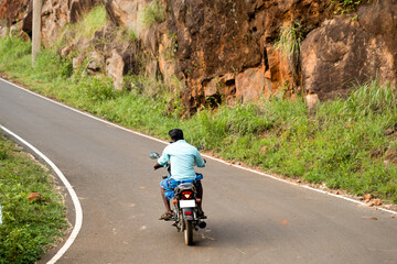 Indian Biker Engaged in Phone Conversation While Riding Motorcycle