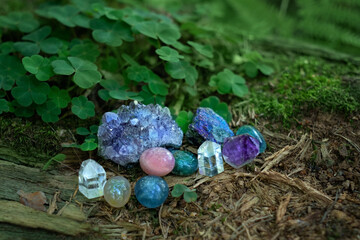 set of different minerals close up on natural forest background. Gemstones for healing Magic...