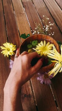 person holding flowers, bowl of flowers, flowers, pretty bowl with flowers, flower, hand, nature, beauty, hands, garden, yellow, woman, plant, daisy, summer, spring, bouquet, holding, wedding, bloom, 