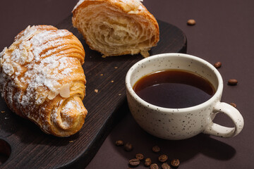 Good morning concept. Breakfast with cup of coffee and fresh croissant. Sweet creamy sauce