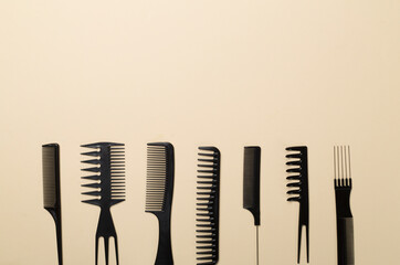 Professional combs and hairdresser tools on color background, top view