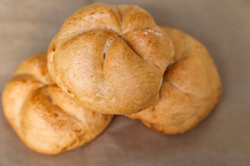 Kaiser rolls on parchment paper, closeup