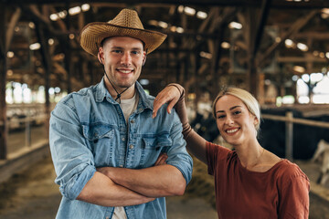 Closeup view of a beautiful woman and man standing in a stall.