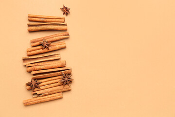 Aromatic cinnamon sticks and anise stars on color background