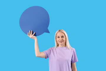 Mature woman with blank speech bubble on blue background