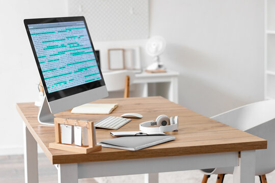 Programmer's workplace with computer in light office