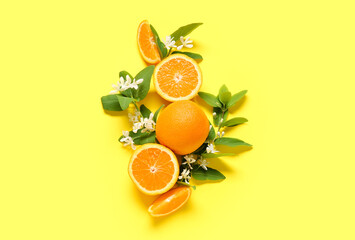 Blooming branches with oranges on yellow background