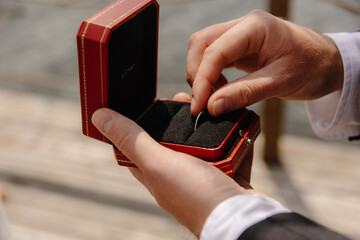 the groom keeps the wedding ring in the box