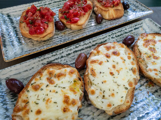 assorted bruschetta with cheese cream and tomatoes