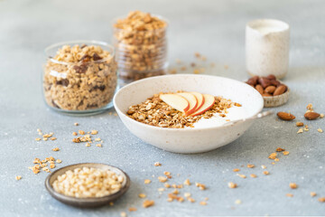 Homemade granola with milk, apples and nuts. Delicious and healthy breakfast.