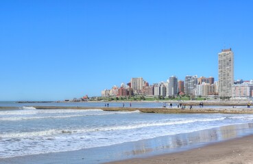 Photo of a beautiful beach in Mar del Plata, Argentina, with a stunning cityscape in the background