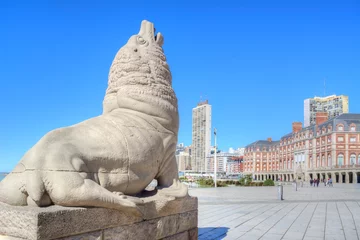 Photo of a majestic lion statue standing proudly in front of a beautiful building in Mar del Plata, Argentina © turventur