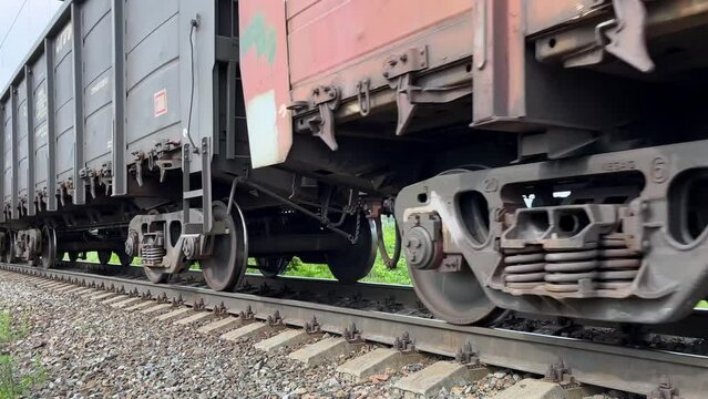 Freight long train rides on rails, close-up. Cargo transport. Railway. Static video. Railway tracks.