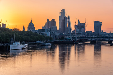 London City skyscrapers and St Paul's Cathedral dome over River Thames on colorful morning - 608807463