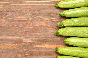Many fresh green zucchini on wooden background