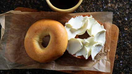 Savory Delights: Close-Up of Cream Cheese-Spread Bagel on a Delectable Food Background in Stunning 4K