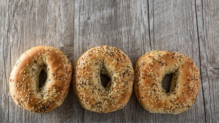 Artisanal Elegance: Top Close-Up of a Sesame Seed Bagel on a Wooden Surface in Exquisite 4K Detail