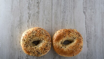 Artisanal Elegance: Top Close-Up of a Sesame Seed Bagel on a Wooden Surface in Exquisite 4K Detail
