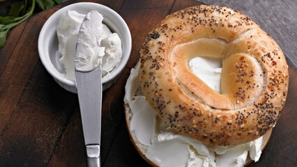 Savory Delights: Close-Up of Cream Cheese-Spread Bagel on a Delectable Food Background in Stunning 4K